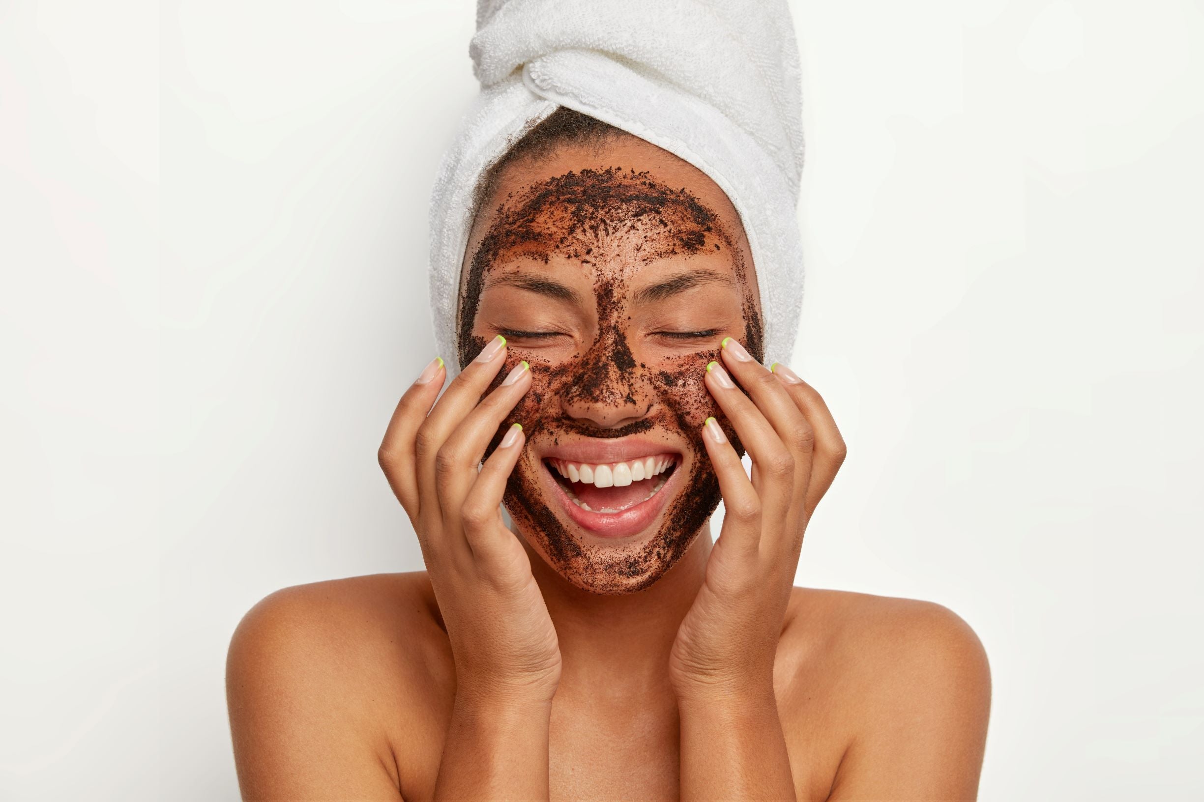 smiling woman using a facial scrub